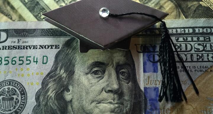 100 dollar bill with graduation cap
