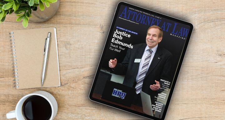 Ipad with magazine cover sitting on desk with coffee and notebook