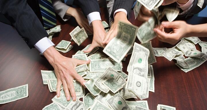 Businesspeople grabbing money