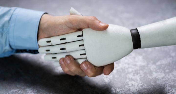 Businessperson And Robot Shaking Hands 
