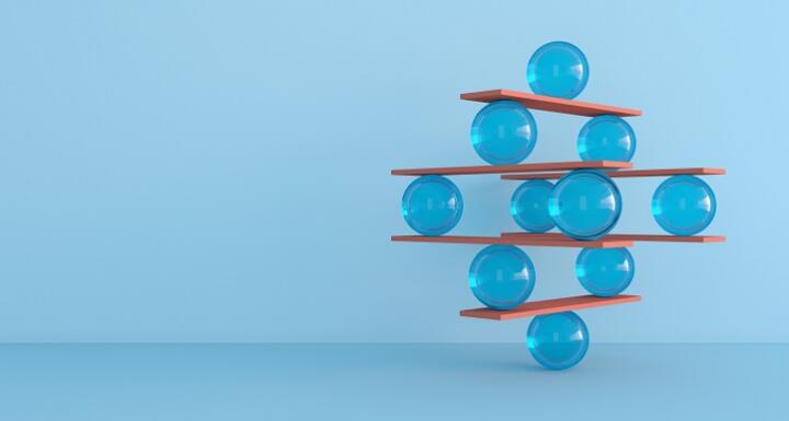 Abstract image of balls balancing on wooden slats in increasing complexity
