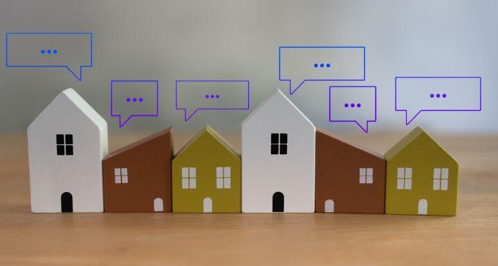 Different size of wooden toy house with speech bubble pop up