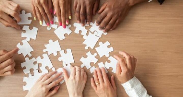 Diverse Group putting together a puzzle