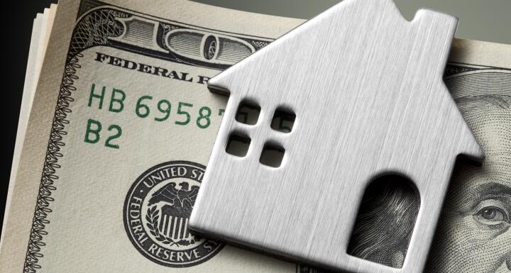 Dollar bills with miniature model house