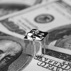 Silver toy present on money