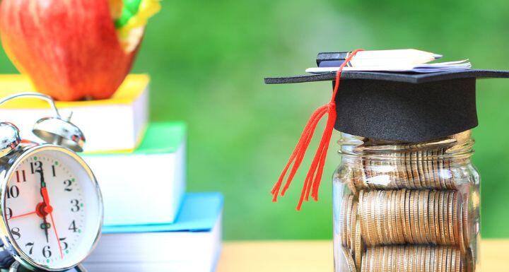 Graduation Hat on glass bottle with books