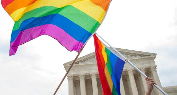 LGBTQ rainbow flag flying in front of Supreme Court building