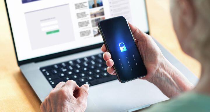 Senior and phone with lock password to protect data in online bank website